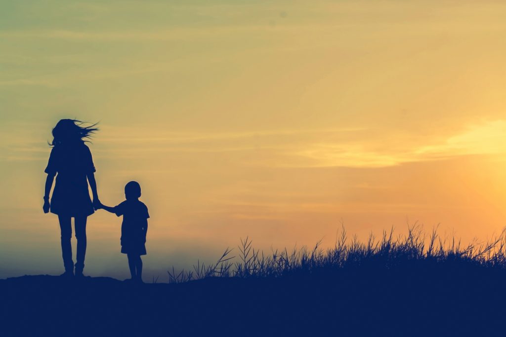 Mother,Encouraged,Her,Son,Outdoors,At,Sunset,,Silhouette,Concept